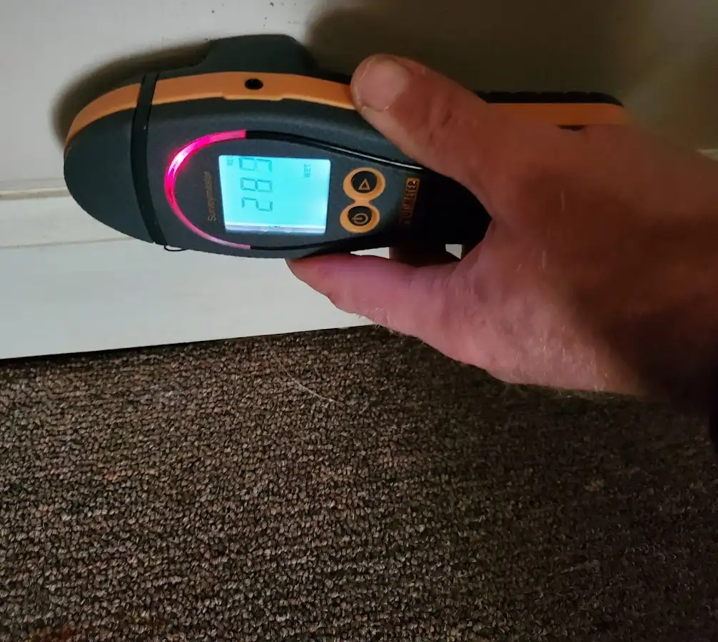 Moisture detection at baseboard during Storm Damage Restoration in Watchung